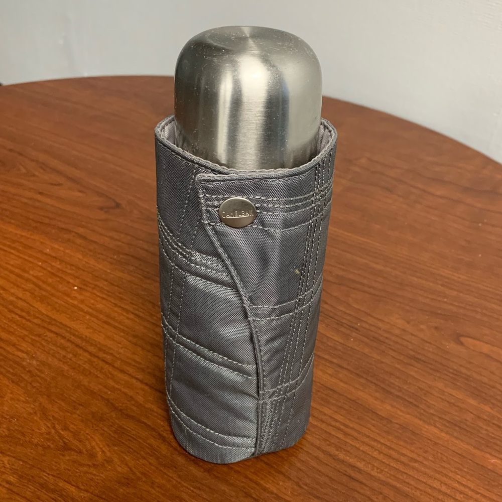 stainless steel vacuum flask with a grey insulated sleeve